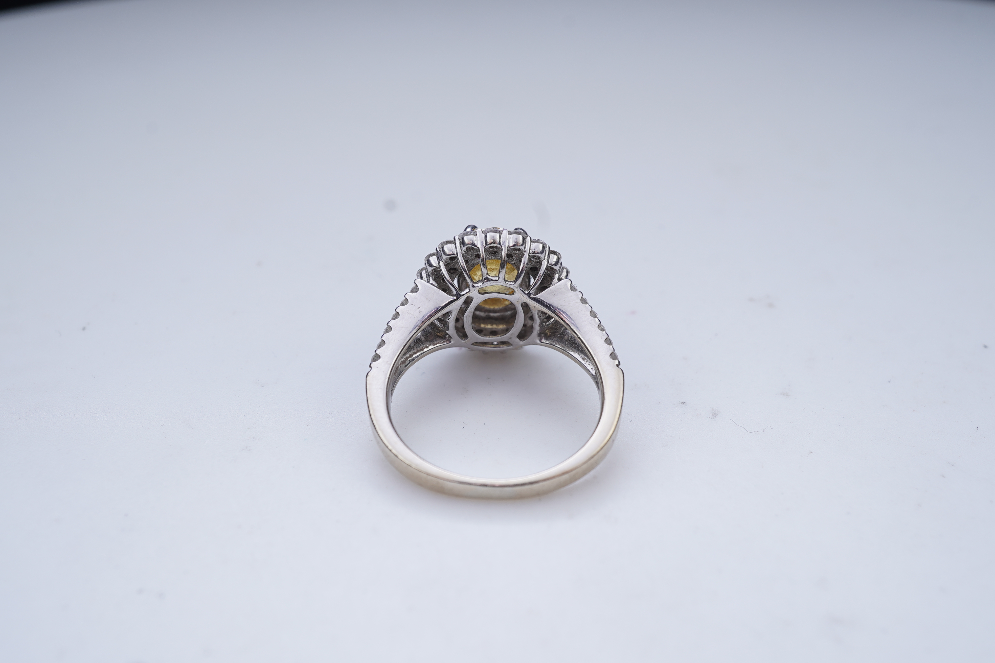 A yellow sapphire and diamond ring